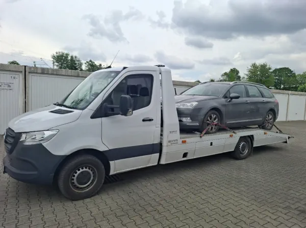 Älteres Diesel Fahrzeug wird wegen kostspieliger technischer Defekte auf einem Autotransporter zur Verwertung abtransportiert