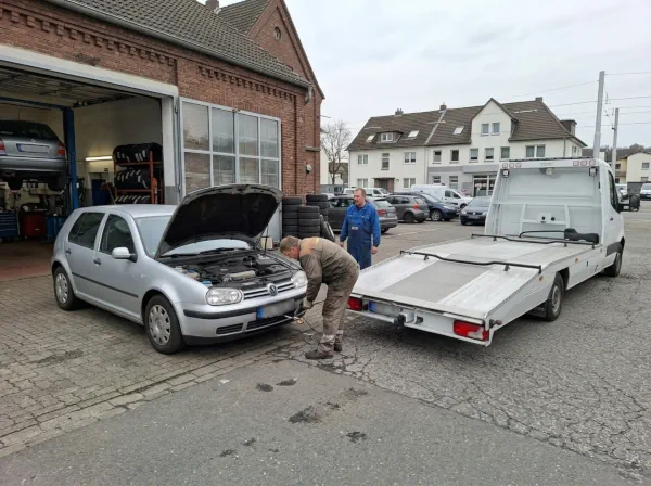 Defektes Auto wird direkt von einer Kfz-Werkstatt mit einem Abschleppwagen abgeholt