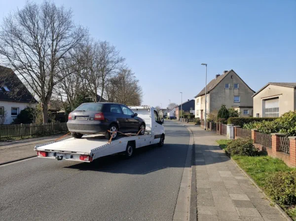 Älteres Fahrzeug wird trotz fehlendem Katalysator auf einem Autotransporter zur Verwertung abtransportiert