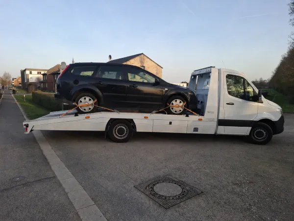 Älterer Kombi wird auf einem Autotransporter zur Fahrzeugverwertung abtransportiert